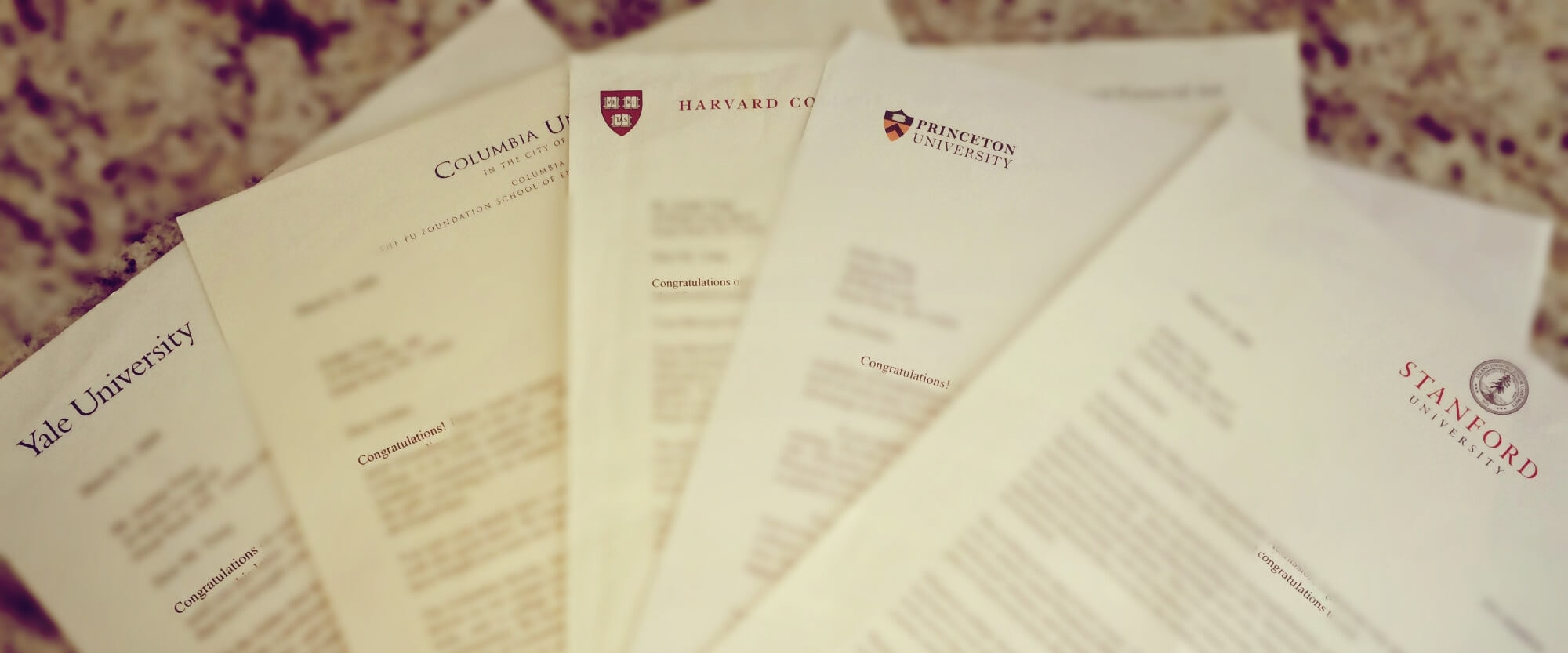 College acceptance letters from Yale, Columbia, Harvard, Princeton, and Stanford